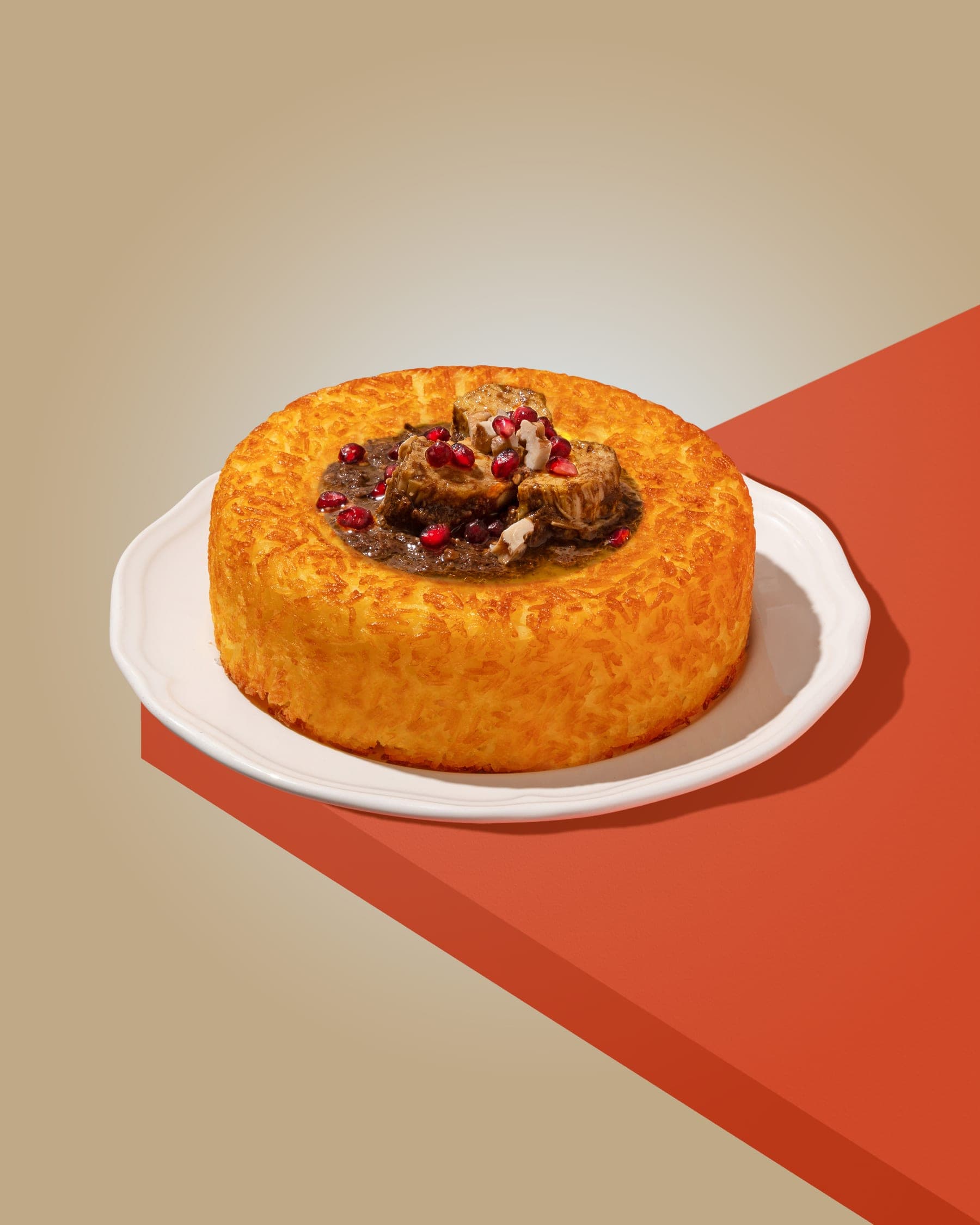 Fesenjan — pomegranate and walnut khoresh over saffron tahdig